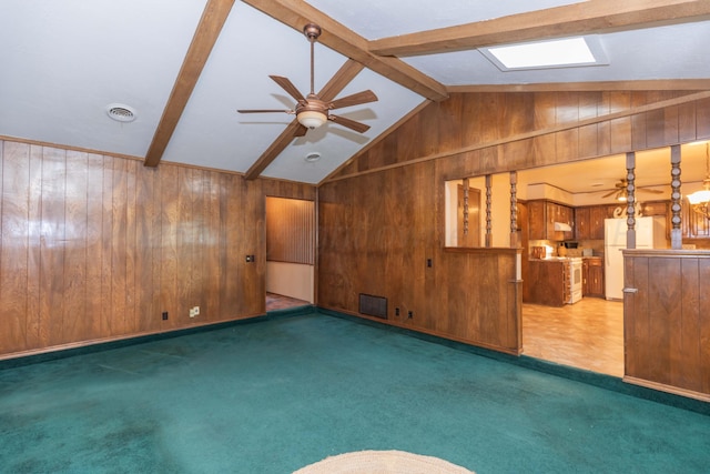 5025 S Fannin St, Amarillo, TX 79110 - unfurnished living room featuring wood walls, carpet flooring, and ceiling fan