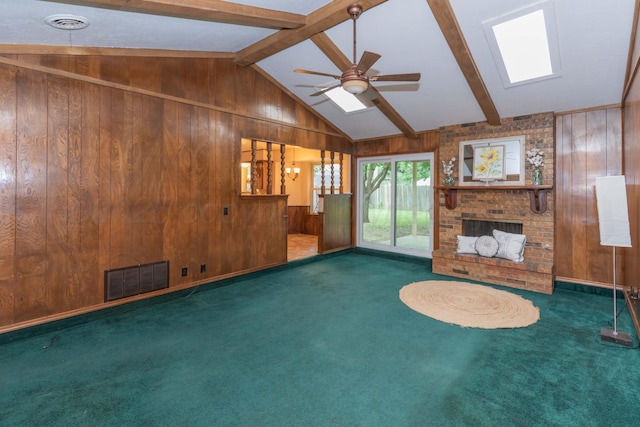 5025 S Fannin St, Amarillo, TX 79110 - unfurnished living room featuring wood walls, carpet floors, ceiling fan, and a fireplace