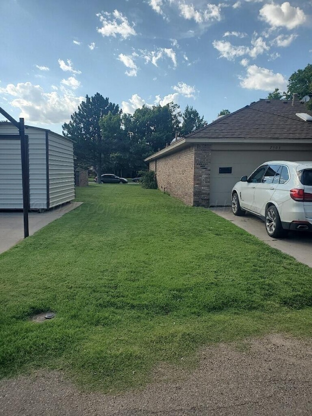7503 Baughman Dr, Amarillo, TX 79121 - view of grassy yard with an attached garage and concrete driveway