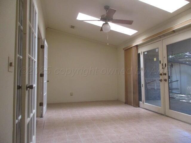 7503 Baughman Dr, Amarillo, TX 79121 - spare room with french doors, a skylight, and ceiling fan