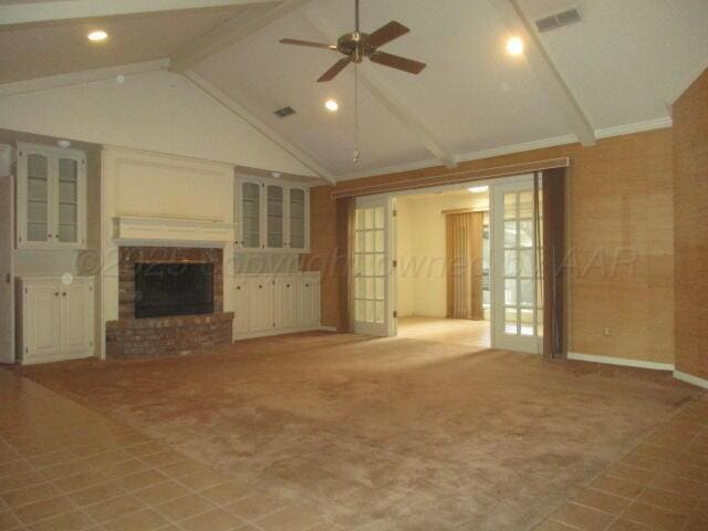 7503 Baughman Dr, Amarillo, TX 79121 - unfurnished living room with a fireplace, ceiling fan, beam ceiling, crown molding, and high vaulted ceiling