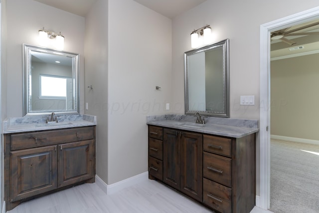 bathroom featuring two vanities, a sink, and visible vents