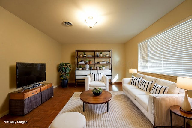 living room featuring dark parquet flooring