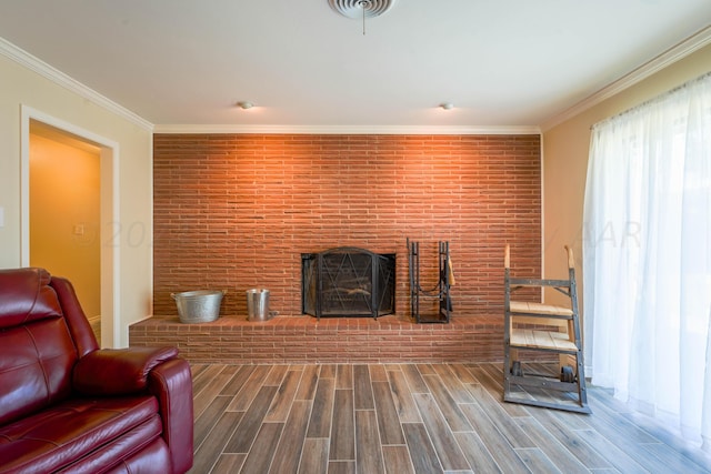 living room with a brick fireplace and ornamental molding