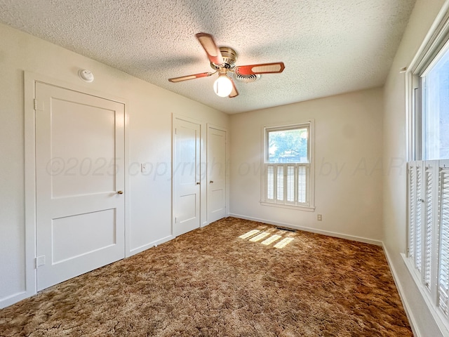 1705 Takewell St, Borger, TX 79007 - unfurnished bedroom with a textured ceiling, carpet, ceiling fan, and baseboards