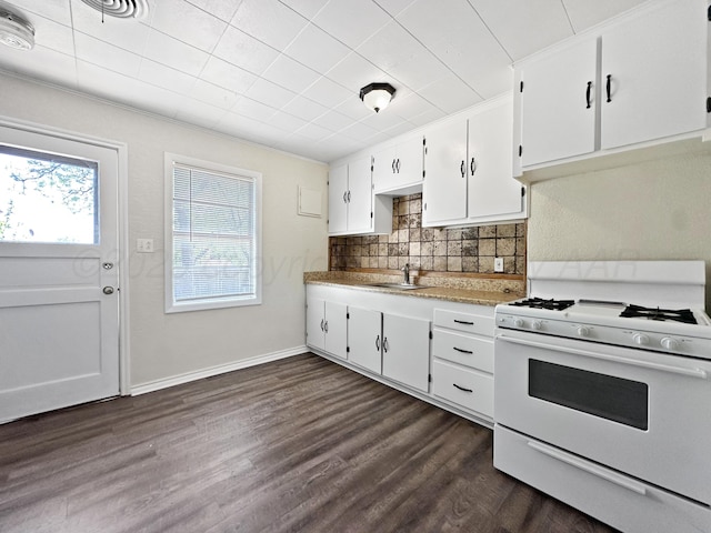 kitchen featuring white cabinets, white gas range oven, a sink, tasteful backsplash, and dark wood-style floors