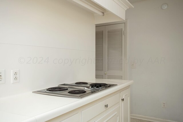 4321 Emil Ave, Amarillo, TX 79106 - kitchen featuring stovetop with downdraft, light countertops, and white cabinetry