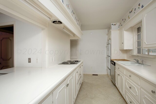 4321 Emil Ave, Amarillo, TX 79106 - kitchen featuring a sink, appliances with stainless steel finishes, light countertops, white cabinets, and baseboards