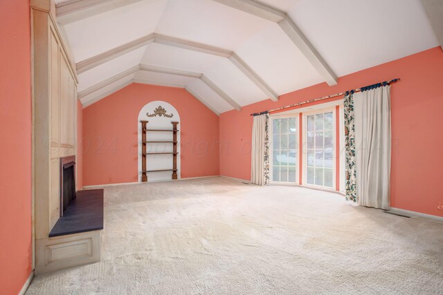 4321 Emil Ave, Amarillo, TX 79106 - unfurnished living room with vaulted ceiling, carpet floors, baseboards, and a fireplace
