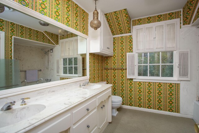 4321 Emil Ave, Amarillo, TX 79106 - full bathroom with wallpapered walls, double vanity, toilet, healthy amount of natural light, and baseboards