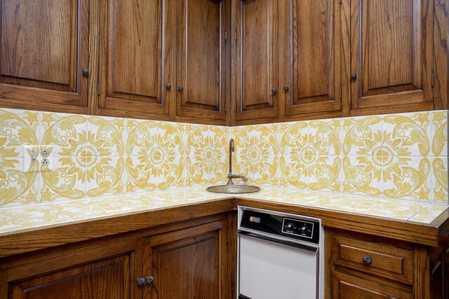 4321 Emil Ave, Amarillo, TX 79106 - kitchen featuring a sink, brown cabinets, and tile counters