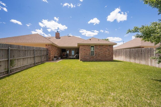 905 Red Deer Ln, White Deer, TX 79097 - back of property with brick siding and a chimney