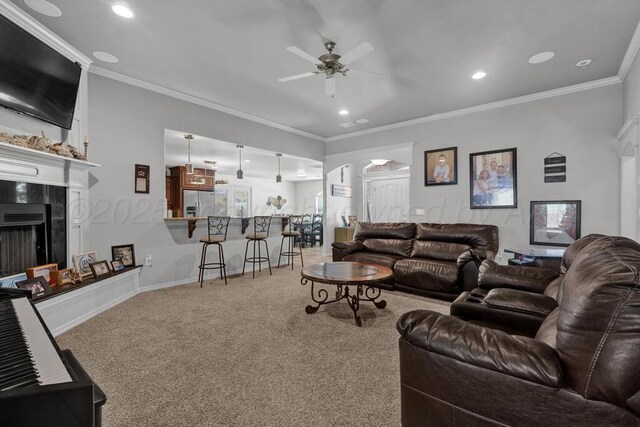 905 Red Deer Ln, White Deer, TX 79097 - carpeted living room featuring a ceiling fan, recessed lighting, a fireplace, and ornamental molding