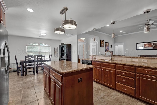 905 Red Deer Ln, White Deer, TX 79097 - kitchen with stainless steel fridge, a sink, a center island, ceiling fan, and hanging light fixtures