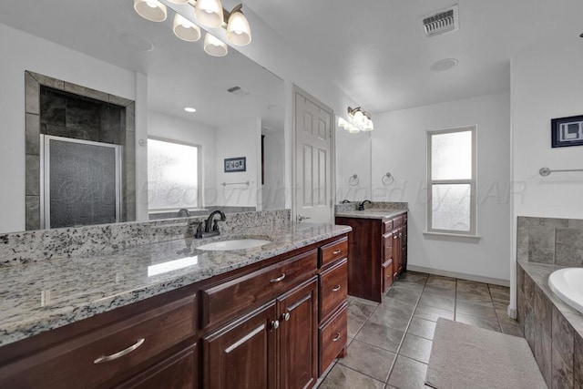 905 Red Deer Ln, White Deer, TX 79097 - full bathroom with a shower stall, a bath, two vanities, tile patterned floors, and baseboards
