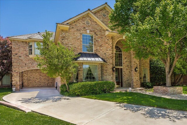 3511 Kensington Pl, Amarillo, TX 79121 - traditional-style home with concrete driveway and brick siding