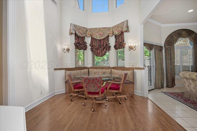 3511 Kensington Pl, Amarillo, TX 79121 - dining space featuring a towering ceiling, wood finished floors, baseboards, and ornamental molding