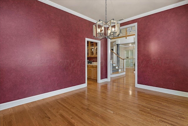 3511 Kensington Pl, Amarillo, TX 79121 - unfurnished dining area with wood finished floors, baseboards, a chandelier, crown molding, and stairway