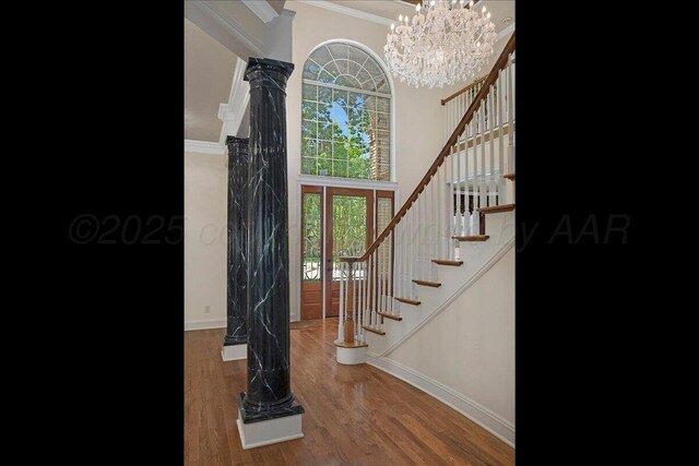 3511 Kensington Pl, Amarillo, TX 79121 - entryway featuring ornamental molding, baseboards, stairway, decorative columns, and wood finished floors
