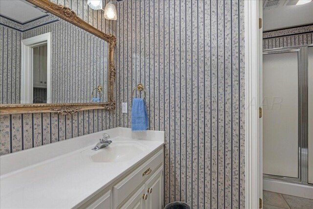 3511 Kensington Pl, Amarillo, TX 79121 - full bathroom with a shower stall, wallpapered walls, vanity, and tile patterned floors