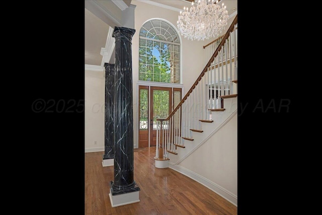 3511 Kensington Pl, Amarillo, TX 79121 - entryway featuring ornamental molding, baseboards, stairway, decorative columns, and wood finished floors