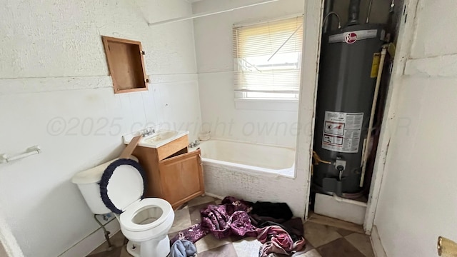 bathroom featuring vanity, a washtub, toilet, and gas water heater
