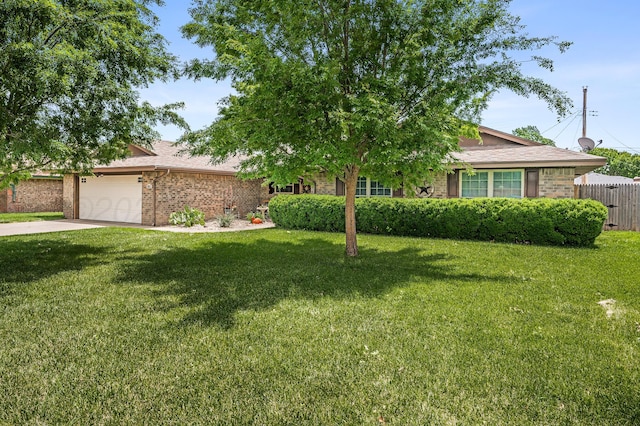 8615 Olympia Dr, Amarillo, TX 79110 - view of property hidden behind natural elements with an attached garage, brick siding, driveway, and a shingled roof