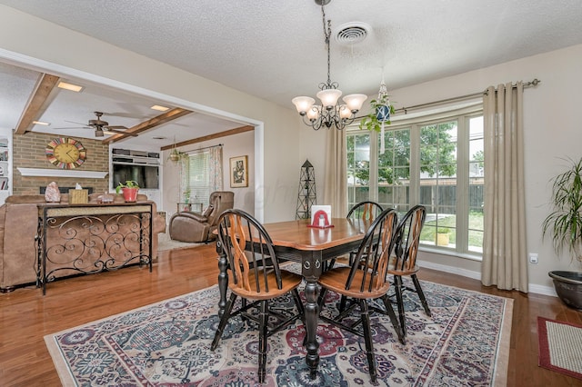 8615 Olympia Dr, Amarillo, TX 79110 - dining area with a ceiling fan, wood finished floors, a chandelier, a textured ceiling, and beam ceiling