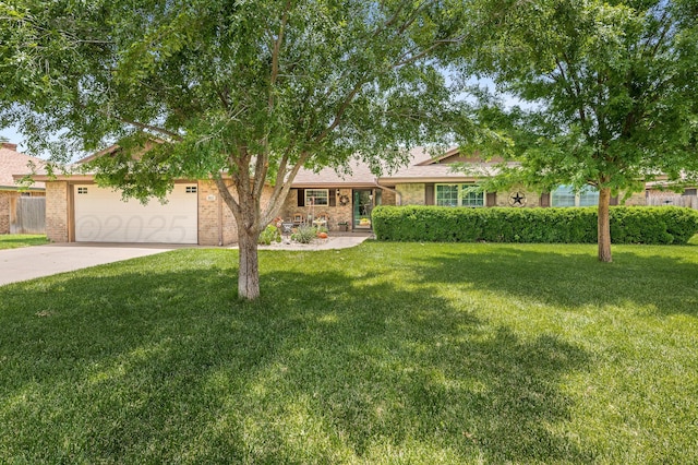 8615 Olympia Dr, Amarillo, TX 79110 - view of front of home featuring an attached garage, concrete driveway, and brick siding