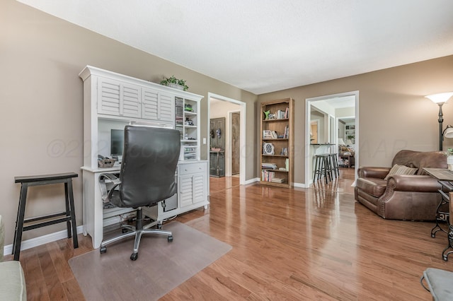 8615 Olympia Dr, Amarillo, TX 79110 - office featuring light wood finished floors, built in shelves, and baseboards