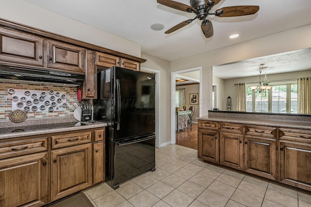 8615 Olympia Dr, Amarillo, TX 79110 - kitchen with black appliances, decorative backsplash, under cabinet range hood, ceiling fan, and light tile patterned flooring