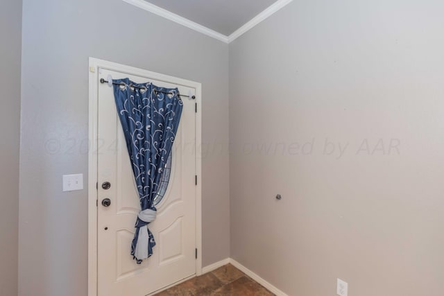 foyer with baseboards and crown molding