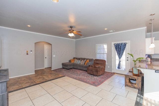 living room with arched walkways, ceiling fan, visible vents, and crown molding