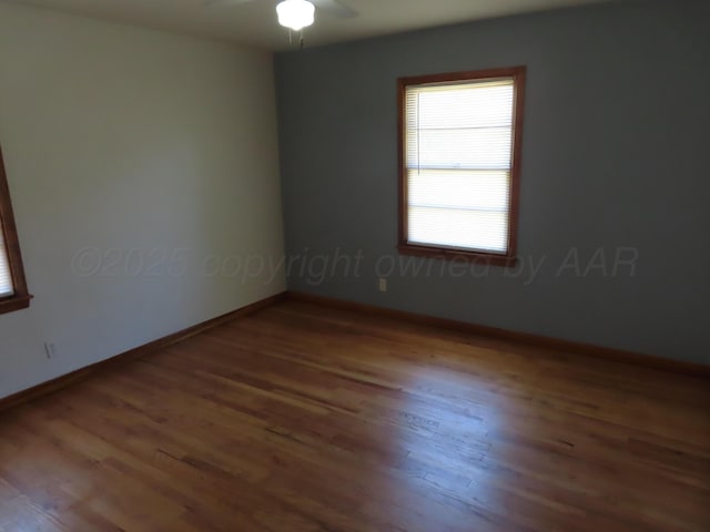 unfurnished room with wood finished floors, ceiling fan, and baseboards