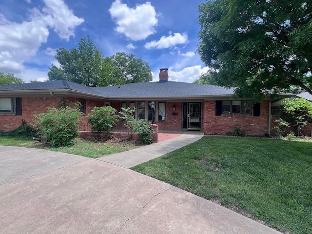 6201 Adirondack Trl, Amarillo, TX 79106 - ranch-style house with brick siding, a front lawn, and a chimney
