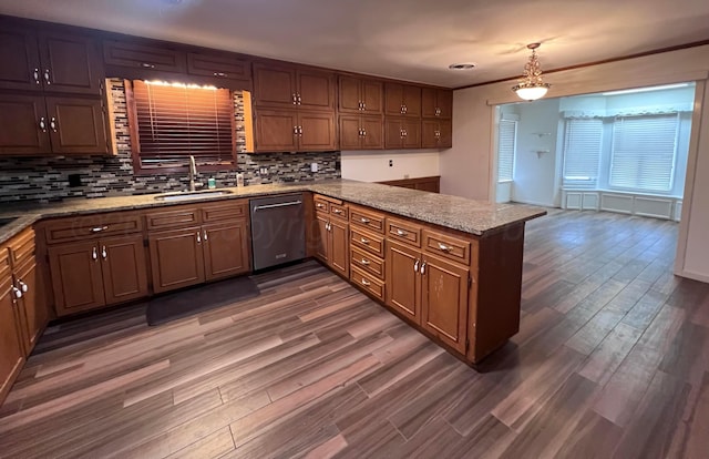 6201 Adirondack Trl, Amarillo, TX 79106 - kitchen featuring stainless steel dishwasher, a peninsula, wood finished floors, decorative backsplash, and light stone counters