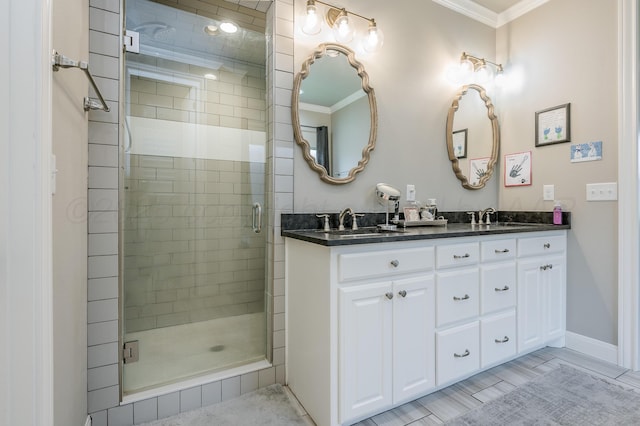 bathroom featuring vanity, a shower with door, and crown molding