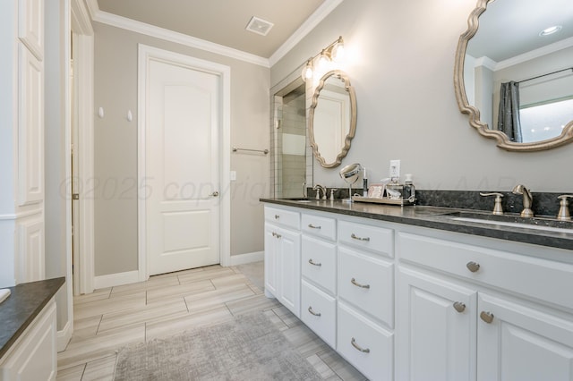 bathroom with crown molding and vanity