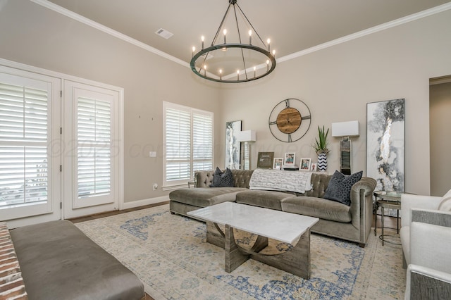 living room with crown molding and an inviting chandelier