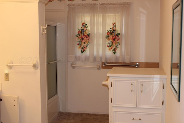 bathroom featuring shower / bath combination with glass door