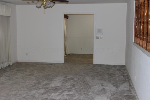 carpeted empty room featuring ceiling fan