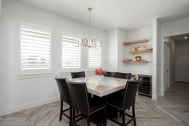 9800 Barton Springs Dr, Amarillo, TX 79119 - dining space with beverage cooler, a chandelier, and baseboards