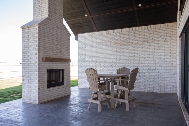 9800 Barton Springs Dr, Amarillo, TX 79119 - view of patio featuring an outdoor brick fireplace and outdoor dining space
