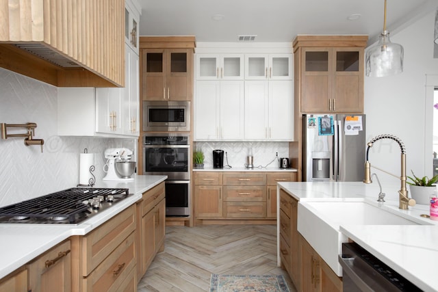 9800 Barton Springs Dr, Amarillo, TX 79119 - kitchen featuring appliances with stainless steel finishes, a sink, light countertops, and backsplash