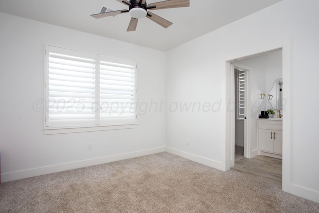 9800 Barton Springs Dr, Amarillo, TX 79119 - spare room with light carpet, a ceiling fan, baseboards, and a sink