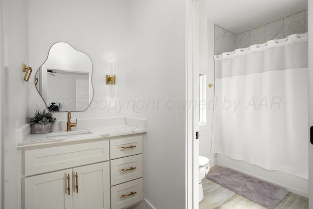 9800 Barton Springs Dr, Amarillo, TX 79119 - full bathroom featuring vanity, toilet, shower / tub combo, and wood finished floors