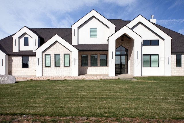 9800 Barton Springs Dr, Amarillo, TX 79119 - modern inspired farmhouse with brick siding, a front yard, and a shingled roof