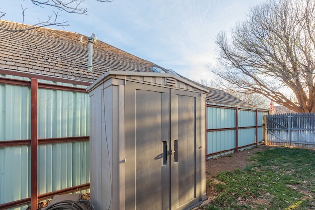view of shed featuring fence