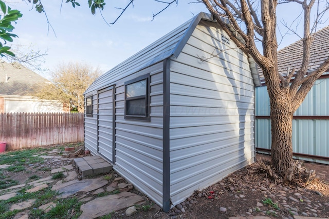 view of outbuilding featuring an outbuilding and fence