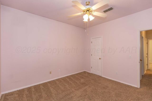 unfurnished room featuring carpet flooring, baseboards, visible vents, and ceiling fan
